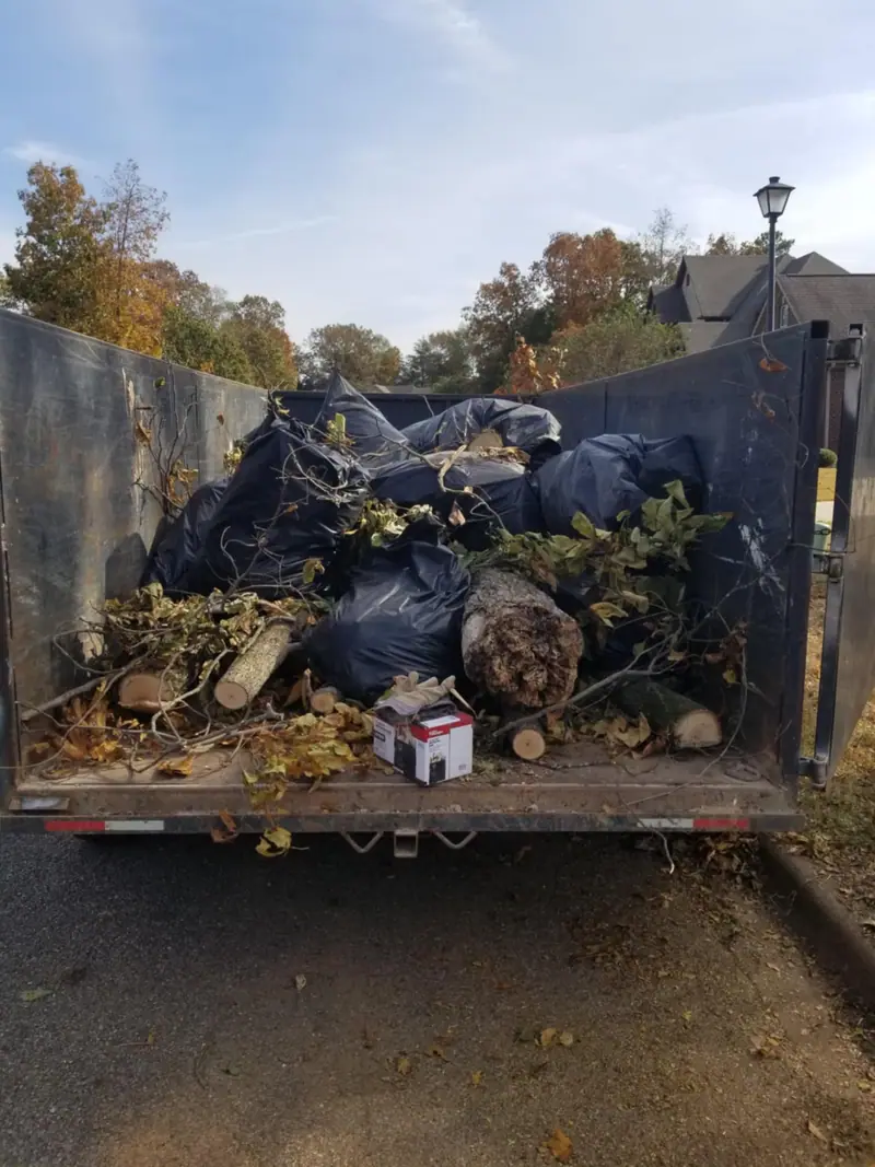 The dump trailer loaded with bagged yard debris